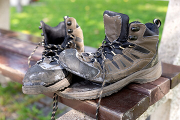 Broken hiking boots after the hike on the bench