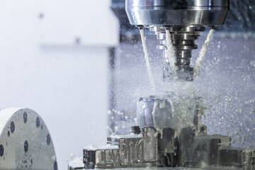 a process of industrial wet milling in 5-axis cnc machine with coolant flow under pressure and...