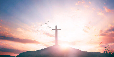 Religious concept: Silhouette cross and birds flying on  sunrise background
