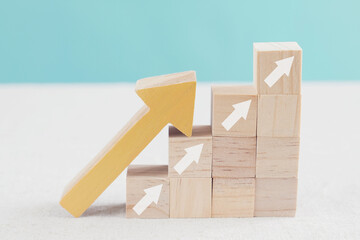 arrows ladder up on wooden blocks, growth and success business concept