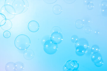 Blue soap bubbles float in the air. Freshness summer natural background.