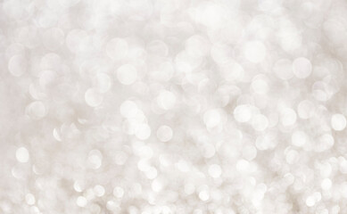 White glitter vintage lights background. Bokeh silver and white. defocused gray background.