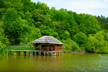 Fototapeta premium cottage on the pontoon of the lake on a beautiful summer day 