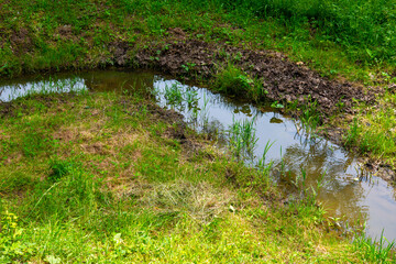 wooden bridge over the river behind the house