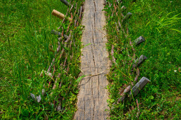 wooden bridge over the river behind the house