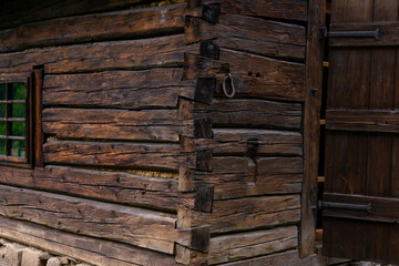 windows and wooden roof of the traditional house made of clay and straw
