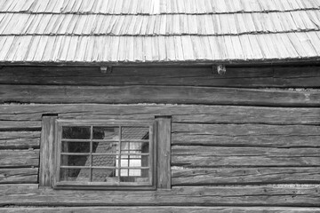 windows and wooden roof of the traditional house made of clay and straw
