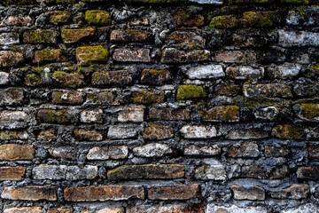 Old walls consisting of piles of red stones are characteristic of a building