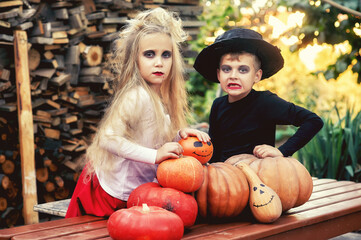 Fototapeta premium Funny kids decorated kids with pumpkins for Halloween day