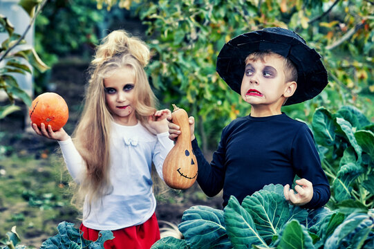 Funny kids decorated kids with pumpkins for Halloween day