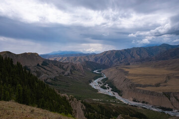 Moutain river valley with sky background. Beautiful wild nature landscape. Adventure travel. Outdoor landscape. Usek river valley in Kazakhstan. Tourism in Kazakhstan concept.