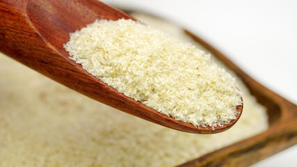 Close up of psyllium (ispaghula) husk in wooden spoon.Psyllium husk also called isabgol is fiber derived from the seeds of Plantago ovata plant found in India. Selective focus.	
