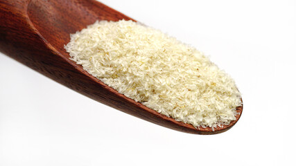 Close up of psyllium (ispaghula) husk in wooden spoon.Psyllium husk also called isabgol is fiber derived from the seeds of Plantago ovata plant found in India. Selective focus.	