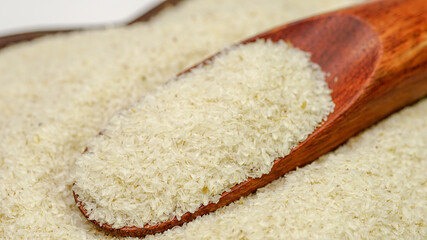 Close up of psyllium (ispaghula) husk in wooden spoon.Psyllium husk also called isabgol is fiber derived from the seeds of Plantago ovata plant found in India. Selective focus.