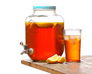 Jar and glass of fresh ice tea on table against white background