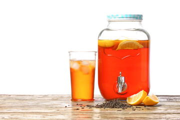 Jar and glass of fresh ice tea on table against white background