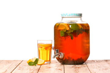 Jar and glass of fresh ice tea on table against white background
