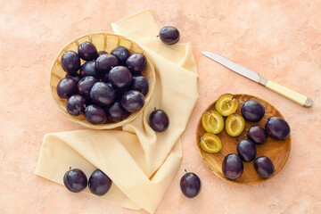 Composition with ripe plums on table