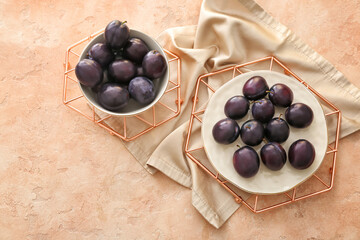 Composition with ripe plums on table