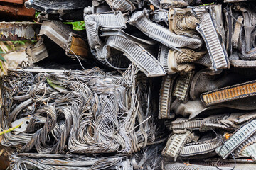 Scrap yard, pressing non-ferrous scrap metal into a cube.