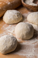 Freshly prepared yeast dough for bread on wooden background.