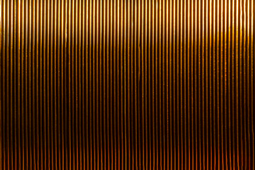 Vertical copper coil texture. Selective soft focus. Bokeh.