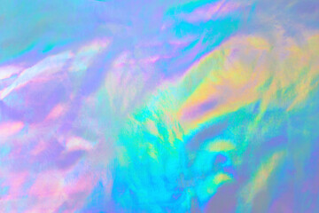 Obraz na płótnie Canvas Abstract Modern pastel colored holographic background in 80s style. Crumpled iridescent foil textile real texture. Synthwave. Vaporwave style. Retrowave, retro futurism, webpunk