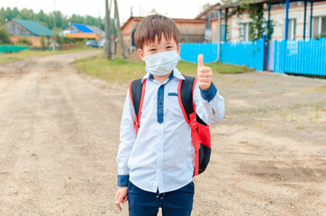 Asian child boy student in school uniform medical face mask and sanitizer back to school epidemic...