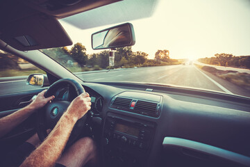 Car dashboard and steering wheel whith hand inside of car. Travel concepte
