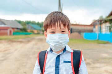 Asian child boy student in school uniform medical face mask and sanitizer back to school epidemic...