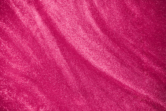 de-focused. Abstract elegant, detailed pink glitter particles flow underwater. Holiday magic shimmering luxury background. Festive sparkles and lights. 
