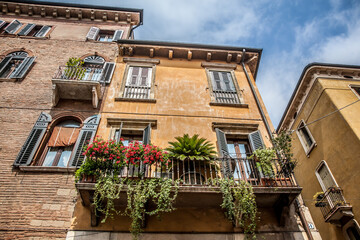 Fototapeta na wymiar Beautiful balcony decorated with flowers in Verona. Veneto, Italy