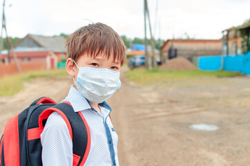 Asian child boy student in school uniform medical face mask and sanitizer back to school epidemic...