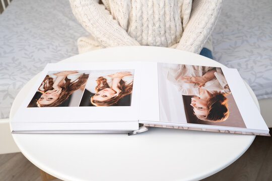 wedding photo book with thick pages on a white table. convenient, beautiful and long-lasting storage of photos from photo sessions.