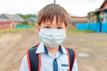 Asian child boy student in school uniform medical face mask and sanitizer back to school epidemic...