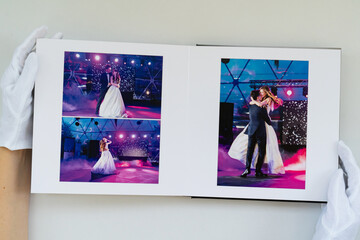 hands in white gloves flipping through a photo book with wedding photos. beautiful and convenient storage of the memory of an important day.