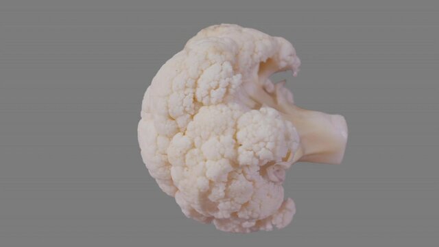 Fresh cauliflower piece spin and float - isolated on neutral gray. Seamless loop for unlimited duration. Alpha channel included for compositing projects.