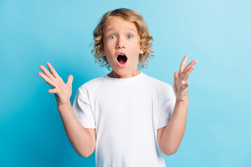 Photo of small boy feel astonished shout loudly wear casual style clothes isolated over blue color background