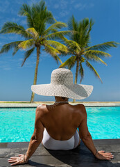 woman in luxury spa resort near the swimming pool.