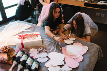 Beautiful happy stylish sexy young girls is preparing for a party in honor of the wedding in home....