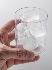 ice cubes in a glass and on the table