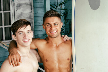 Two young attractive guys are relaxing on the beach.