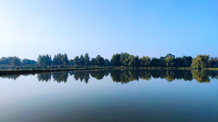 Fishing lake in the foggy morning