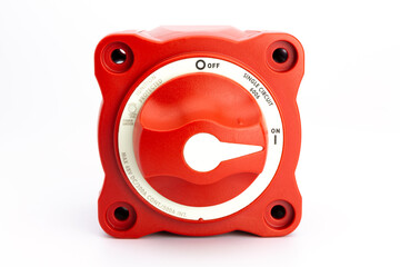 Front view of a red on/off rotary switch, turned on, with white background