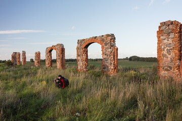 City Smiltene, Latvia.Old brick stonehenge and photographer.