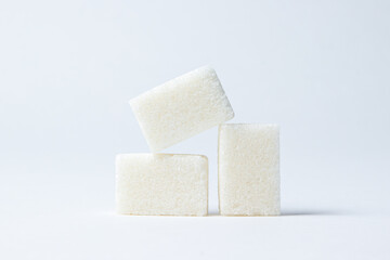 Refined sugar on a white background. White sugar cubes.