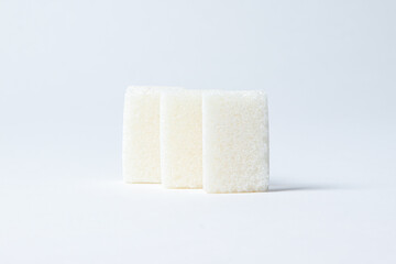 Refined sugar on a white background. White sugar cubes.