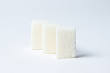 Refined sugar on a white background. White sugar cubes.