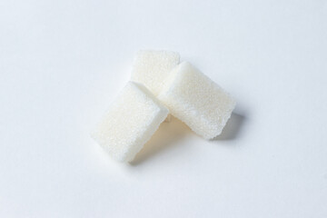 Refined sugar on a white background. White sugar cubes.