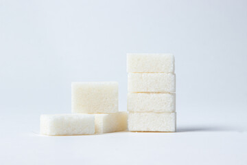 Refined sugar on a white background. White sugar cubes.